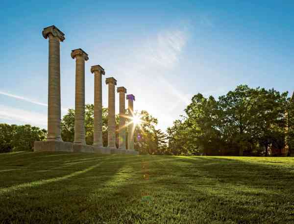 The sun shining through the columns on the Quad on Mizzou's campus.